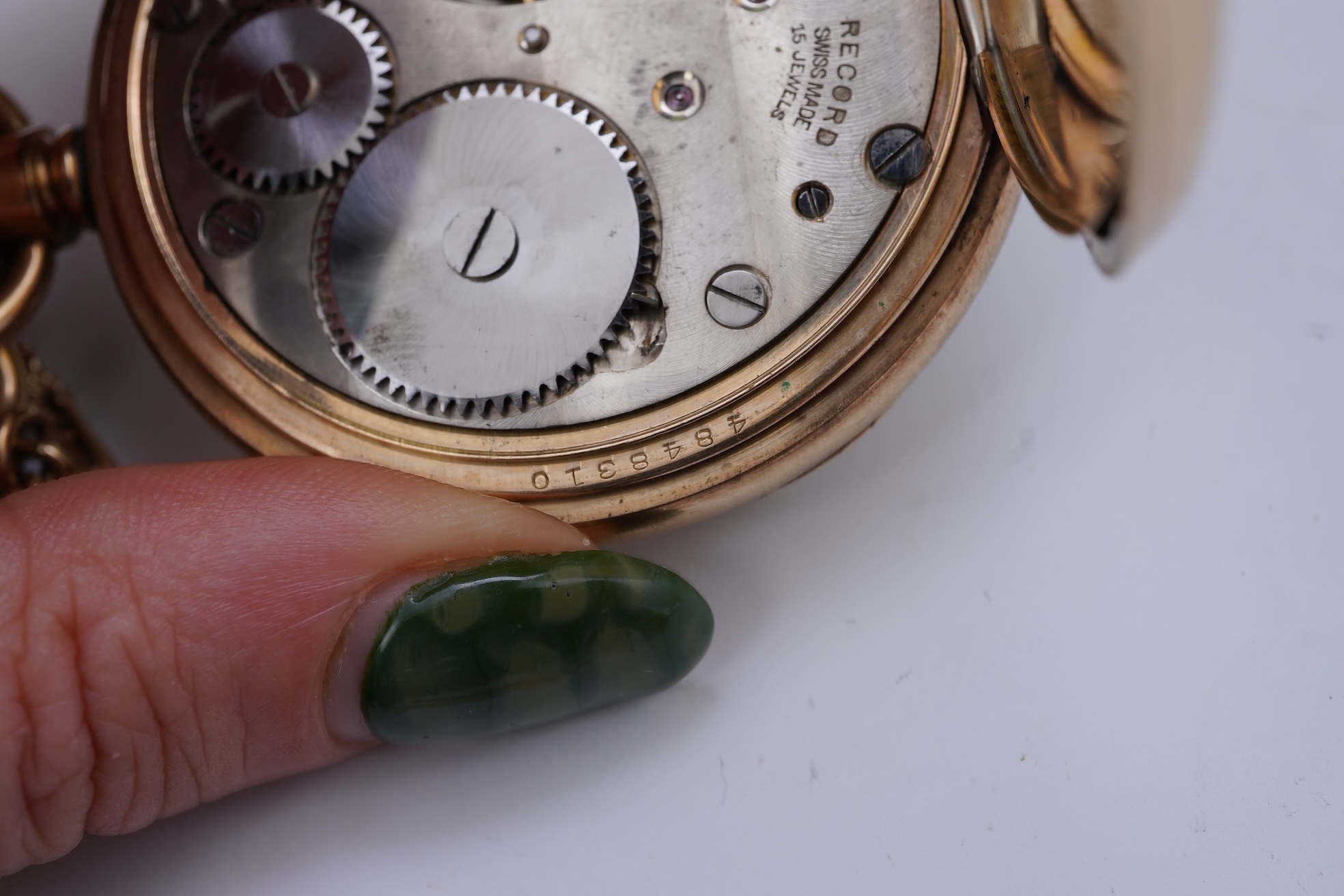 An amethyst fob seal, a gold Albert chain, and a pocket watch